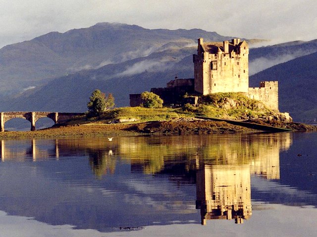 Eilean Donan Castle Scotland UK - Eilean Donan Castle with its enchantingly beautiful reflection in the water at dusk, surrounded by majestic scenery, is one of the most iconic landmarks in UK and in the world. The castle was built in the 13th century (1220), on a small island in Loch Duich in western highlands of Scotland, for defence against Vikings. The castle was named after Bishop Donan who arrived in the country in the 6th century. After it has been rebuilt several times, since 1932 the Eilean Donan Castle was re-opened to public. - , Eilean, Donan, castle, castles, Scotland, UK, places, place, travel, travels, tour, tours, trip, trips, enchantingly, beautiful, reflection, reflections, water, waters, dusk, majestic, scenery, sceneries, iconic, attractions, landmark, landmarks, world, 13th, century, centuries, 1220, island, islands, Loch, Duich, western, highlands, highland, defence, defences, Vikings, bishop, bishops, Donan, country, countries, 1932, public - Eilean Donan Castle with its enchantingly beautiful reflection in the water at dusk, surrounded by majestic scenery, is one of the most iconic landmarks in UK and in the world. The castle was built in the 13th century (1220), on a small island in Loch Duich in western highlands of Scotland, for defence against Vikings. The castle was named after Bishop Donan who arrived in the country in the 6th century. After it has been rebuilt several times, since 1932 the Eilean Donan Castle was re-opened to public. Решайте бесплатные онлайн Eilean Donan Castle Scotland UK пазлы игры или отправьте Eilean Donan Castle Scotland UK пазл игру приветственную открытку  из puzzles-games.eu.. Eilean Donan Castle Scotland UK пазл, пазлы, пазлы игры, puzzles-games.eu, пазл игры, онлайн пазл игры, игры пазлы бесплатно, бесплатно онлайн пазл игры, Eilean Donan Castle Scotland UK бесплатно пазл игра, Eilean Donan Castle Scotland UK онлайн пазл игра , jigsaw puzzles, Eilean Donan Castle Scotland UK jigsaw puzzle, jigsaw puzzle games, jigsaw puzzles games, Eilean Donan Castle Scotland UK пазл игра открытка, пазлы игры открытки, Eilean Donan Castle Scotland UK пазл игра приветственная открытка