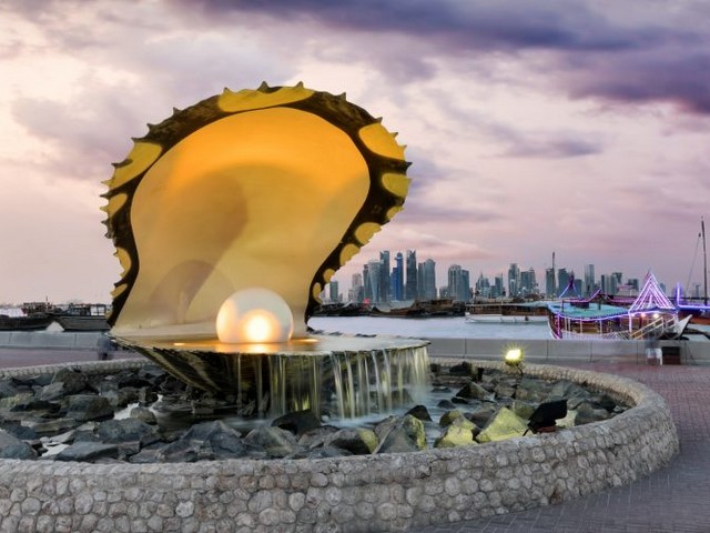 Pearl Monument Doha Qatar - The Pearl Monument in Doha pays homage to Qatar's history, when the pearling was one of primary revenue streams prior to the discovery of oil in 1939. It was extremely dangerous job due to the heavy diving and the constant threat of barracudas, sea snakes, and sharks. Approximately one in 10,000 oysters contains a pearl. <br />
Pearl diving was a seasonal activity and profession that took place between June and September each year. But as Japan began cultivating pearl and creating oyster farms in the mid-1920s, pearl prices decreased. Coupled with the discovery of oil, Qatar’s priorities underwent a massive shif and today it boasts the highest per capita income in the world.<br />
The luxury artificial island called The Pearl was built on one of the nation’s major pearl-diving sites.<br />
The Pearl Monument is  located on Corniche Street, at the entrance to the Dhow Harbor. The fountain sculpture depicts a giant open oyster presenting a massive pearl in its mouth, which lights up at night. - , Pearl, Monument, Doha, Qatar, places, place, homage, history, revenue, streams, oil, 1939, dangerous, job, diving, threat, barracudas, sea, snakes, sharks, oysters, seasonal, activity, profession, June, September, Japan, farms, priorities, income, world, luxury, artificial, island, Corniche, Street, Dhow, Harbor, fountain, sculpture, mouth, night - The Pearl Monument in Doha pays homage to Qatar's history, when the pearling was one of primary revenue streams prior to the discovery of oil in 1939. It was extremely dangerous job due to the heavy diving and the constant threat of barracudas, sea snakes, and sharks. Approximately one in 10,000 oysters contains a pearl. <br />
Pearl diving was a seasonal activity and profession that took place between June and September each year. But as Japan began cultivating pearl and creating oyster farms in the mid-1920s, pearl prices decreased. Coupled with the discovery of oil, Qatar’s priorities underwent a massive shif and today it boasts the highest per capita income in the world.<br />
The luxury artificial island called The Pearl was built on one of the nation’s major pearl-diving sites.<br />
The Pearl Monument is  located on Corniche Street, at the entrance to the Dhow Harbor. The fountain sculpture depicts a giant open oyster presenting a massive pearl in its mouth, which lights up at night. Solve free online Pearl Monument Doha Qatar puzzle games or send Pearl Monument Doha Qatar puzzle game greeting ecards  from puzzles-games.eu.. Pearl Monument Doha Qatar puzzle, puzzles, puzzles games, puzzles-games.eu, puzzle games, online puzzle games, free puzzle games, free online puzzle games, Pearl Monument Doha Qatar free puzzle game, Pearl Monument Doha Qatar online puzzle game, jigsaw puzzles, Pearl Monument Doha Qatar jigsaw puzzle, jigsaw puzzle games, jigsaw puzzles games, Pearl Monument Doha Qatar puzzle game ecard, puzzles games ecards, Pearl Monument Doha Qatar puzzle game greeting ecard