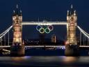 Tower Bridge and Olympic Rings glowing over the River Thames in London UK